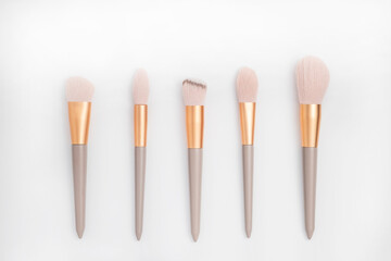 Cosmetic brushes on white background. Set of makeup brushes