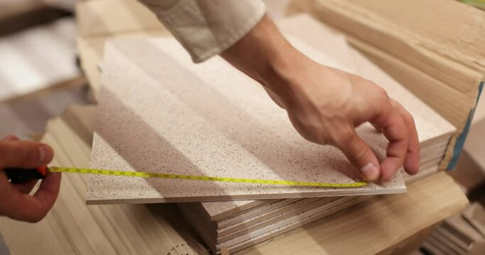 Man chooses ceramic tiles in market