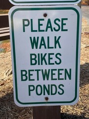 Please Walk Bikes Between Ponds Sign