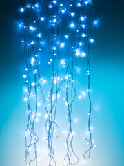 blue white garland with small led bulbs on dark background