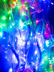 Fototapeta premium multicolored garland with small led bulbs on a dark background