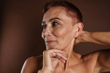 Fototapeta premium Senior shirtless woman smiling while posing on camera