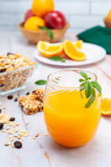 natural orange juice with fruits and nuts and cereals for a healthy breakfast or snack