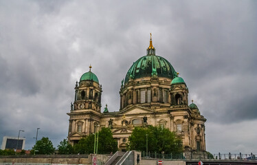 Fototapeta na wymiar Great view of the west front of the Berlin Cathedral (Berliner Dom), a monumental German Evangelical church and dynastic tomb on the Museum Island on a cloudy day in central Berlin, Germany.