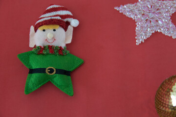 decorative miniature star elf isolated on red background. Christmas ornament and postcard. Christmas, winter, new year concept. Flat lay, copy space.