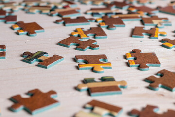 two pieces of a puzzle on a wooden table