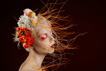 A girl with lively curly hair and flowers in her head. Art object. Flower Fairy