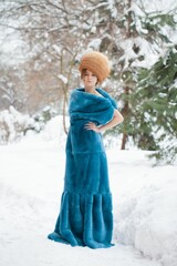 Young blonde girl in fur coat