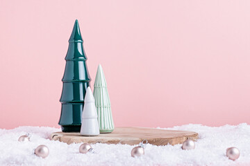 Christmas holiday wooden podium or stand in snow with ceramic Christmas trees