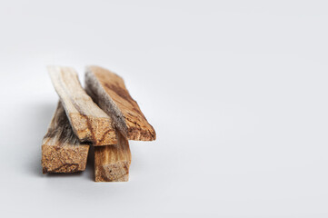 Palo Santo bars close-up and copy space. Ritual cleansing with sacred ibiocai, meditation, aromatherapy with incense and candles..
