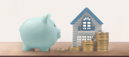 Model of detached miniature house mock and coins