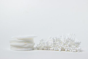 Cotton buds and cotton pads on a white background. Means for cleaning and personal hygiene.
