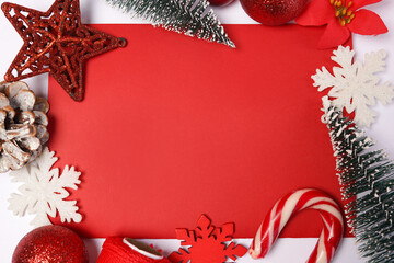 Christmas frame with red ornaments and decorations, greeting card with copy space