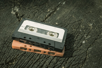 an old audio tape on a dry log