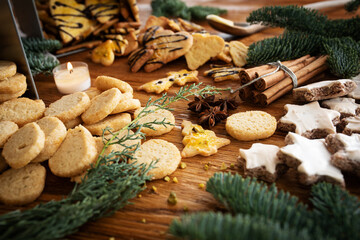 Different homemade christmas cookies with spices on vintage wood. Background for the sweet christmas baking.