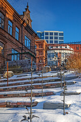 Historic red brick building under restoration on a sunny winter day