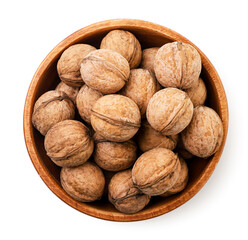 Walnuts in a wooden plate on a white background. Top view