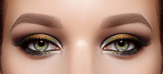 Closeup Macro of Woman Face with Green Eyes Make-up. Fashion Celebrate Makeup, Glowy Clean Skin,...
