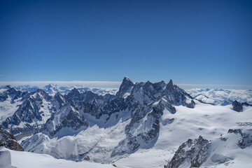 A view of the French Alps, Swiss Alps, and Italian Alps on a sunny summer day from the Aiguille du Midi near Mont Blanc in Chamonix, France