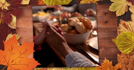Composite image of couple holding hands at thanksgiving dinner party and autumn leaves, copy space