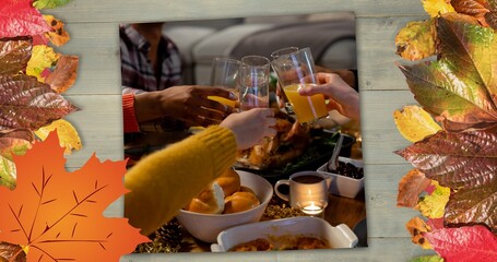 Composite image of people toasting drinks at thanksgiving dinner party and autumn leaves, copy space