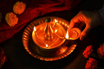 Indian woman holding lighting oil lamp Pongal Onam Diwali vishu celebration Indian festival...