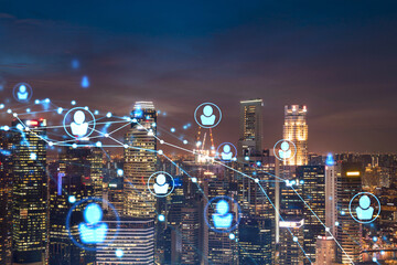 Glowing Social media icons on night panoramic city view of Singapore, Asia. The concept of networking and establishing new connections between people in businesses. Double exposure.