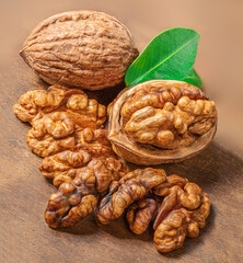 Walnut. Fresh Walnut kernel Nut on wooden background. Organic walnut with green leaves.