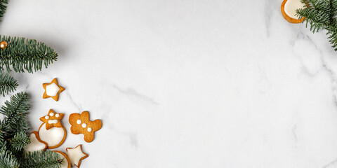Banner of Сhristmas Сookies stars and Gingerbread Man on white marble background with Christmas tree. Top view. Happy New Year