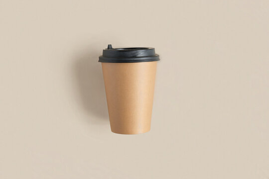 Top View Of A Brown Coffee Paper Cup. Mockup With Lid. Set Of Craft Paper Cups For Coffee Or Tea On Beige Background. Flat Lay. Zero Waste, Plastic Free Concept. Disposable Recycled Cups