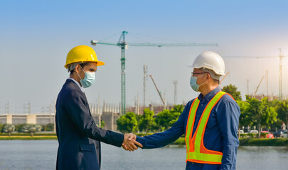 Teamwork Engineer and businessman handshake at construction site