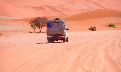 Off road vehicle driving through desert - Four-wheel-drive vehicle in the desert - Namibia © muratart