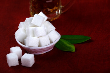 Refined sugar cubes on Red background.