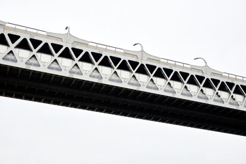 Minimal background image of high tech metal bridge against white sky, copy space