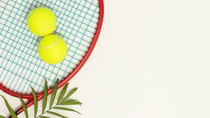 Tennis. Sport composition with yellow tennis balls on a racket with palm leaf on a white background...