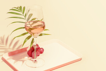 The concept of a tropical holiday resort and relax. Drink composition with a glass of rose wine...