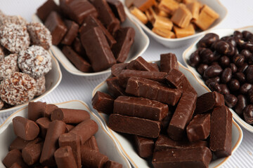 Festive Happy New Year's table full of chocolates. Assortment of delicious chocolate candies background