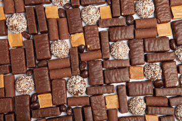 Festive Happy New Year's table full of chocolates. Assortment of delicious chocolate candies background