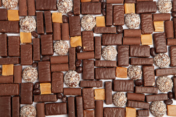 Festive Happy New Year's table full of chocolates. Assortment of delicious chocolate candies background
