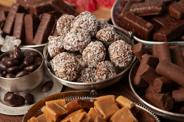 Festive Happy New Year's table full of chocolates. Assortment of delicious chocolate candies background