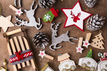 Wooden christmas tree decor on brown background, eco-friendly Christmas toys. Copy space