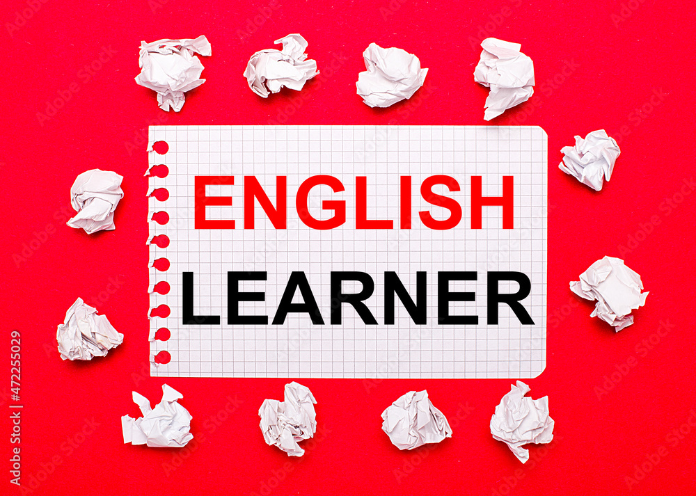 Poster on a bright red background, white crumpled sheets of paper and a sheet of paper with the text englis