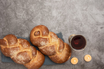 Shabbat Shalom - challah bread, shabbat wine and candles on wooden table - obrazy, fototapety, plakaty