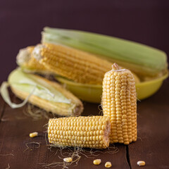 Grains of ripe corn on wooden background