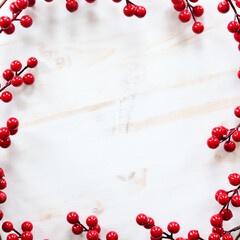 Frame of red berries on white wood with copy space