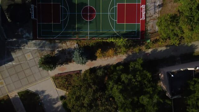 Overflight over the park coastal zone. Sports ground in the park and the Black Sea coast. Top view 4k drone video