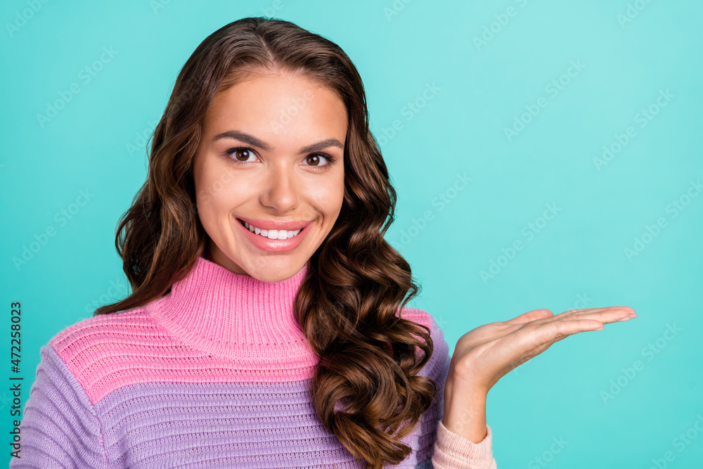 Sticker Photo of cute brunette young lady hold present on arm wear violet sweater isolated on teal color background