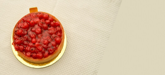 classic red berry curd tart on glod plate on table with copy space