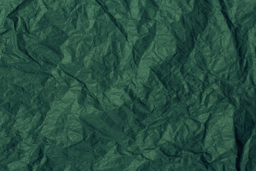 Dark green crumpled paper background