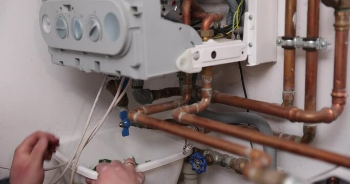 HVAC Worker Repairing Gas Heater. Gas boiler service, central heating system inspection.